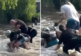 Woman miraculously survives being sucked through flood tunnel as rescuers become victims themselves trying to pull her out