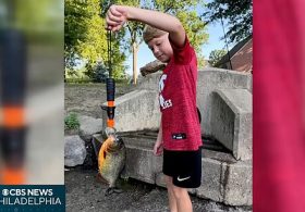 Wild moment boy, 8, captures piranha while fishing in lake in rare feat