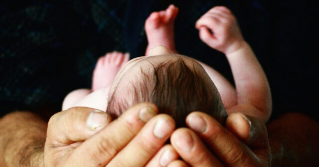 First Safe Haven Baby Box in Georgia to Open Soon Baby cradled in mans hands 640x335 1