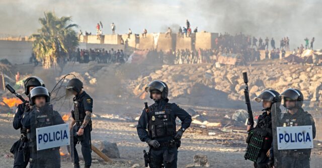Spanish Police Fire Warning Shots During Growing Tensions Outside Ceuta Migrant Shelter Ceuta police gather 640x335 1
