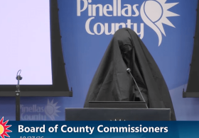 Female wearing Muslim burqa stands at mic during Florida public meeting, reports say. What she does next gets her kicked out.