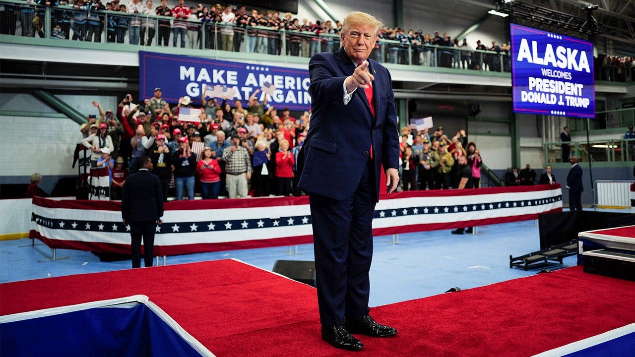 Trump signs pardons for Alaska diesel mechanics onstage during rally touting major energy deals trump greets supporters wasilla alaska