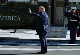 Does video show Trump waving at, saluting nobody before boarding Marine One?