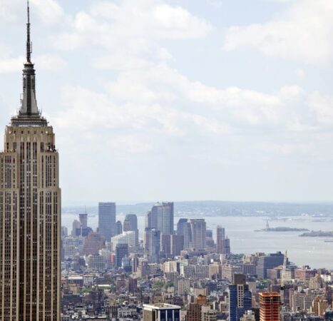 Two People Climb to the Top of Empire State Building Antenna, Fly Banner with Message